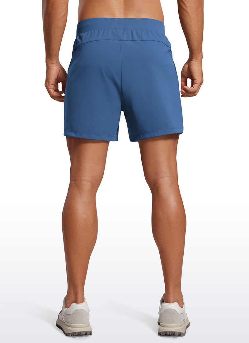 CRZ YOGA Men's Train Relaxed Fit On the Travel Linerless Shorts 5'' Pitch Blue