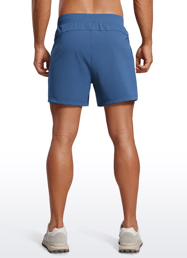 CRZ YOGA Men's Train Relaxed Fit On the Travel Linerless Shorts 5'' Pitch Blue