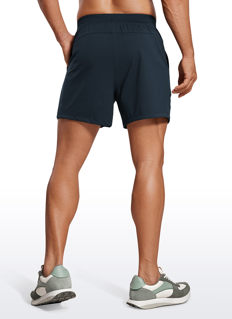 CRZ YOGA Men's Train Relaxed Fit On the Travel Linerless Shorts 5'' True Navy