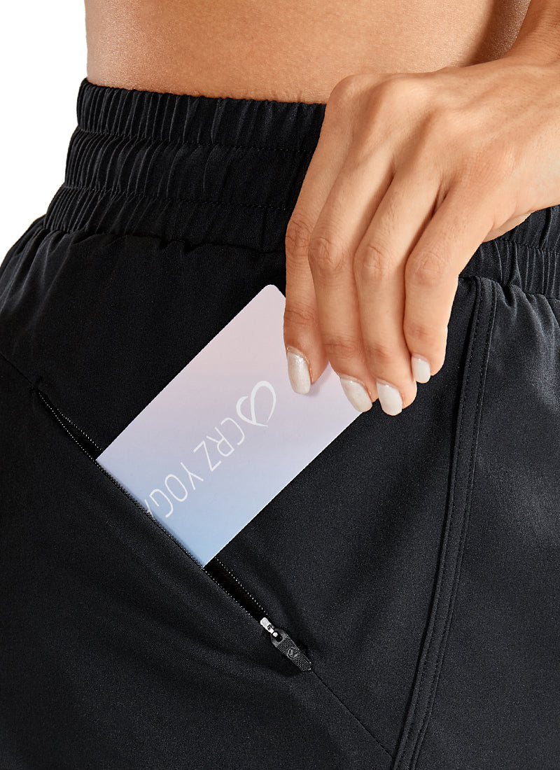 CRZ YOGA Women's Run Feathery-Fit Mid-Rise Lined Shorts Zip Pocket 3'' Black