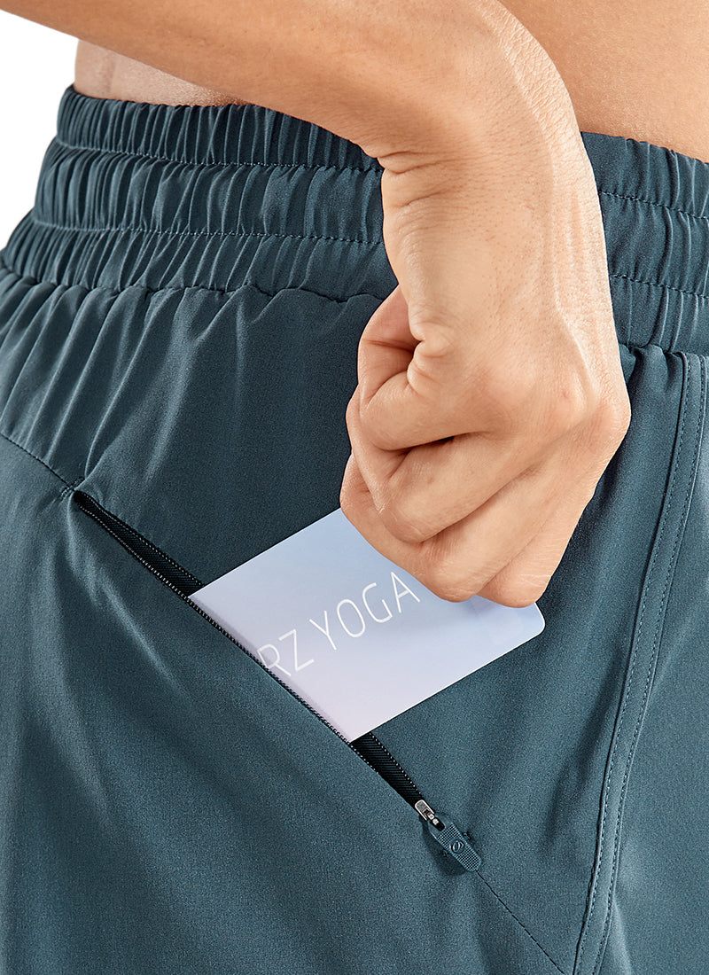 CRZ YOGA Women's Run Feathery-Fit Mid-Rise Lined Shorts Zip Pocket 3'' Stelindigo